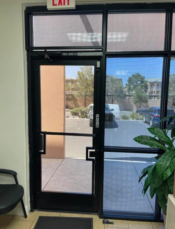 Commercial Storefront Security Screens for Doors and Windows — interior view of a commercial lobby mesh push door with a side mesh panel in Las Vegas, by Olson Iron