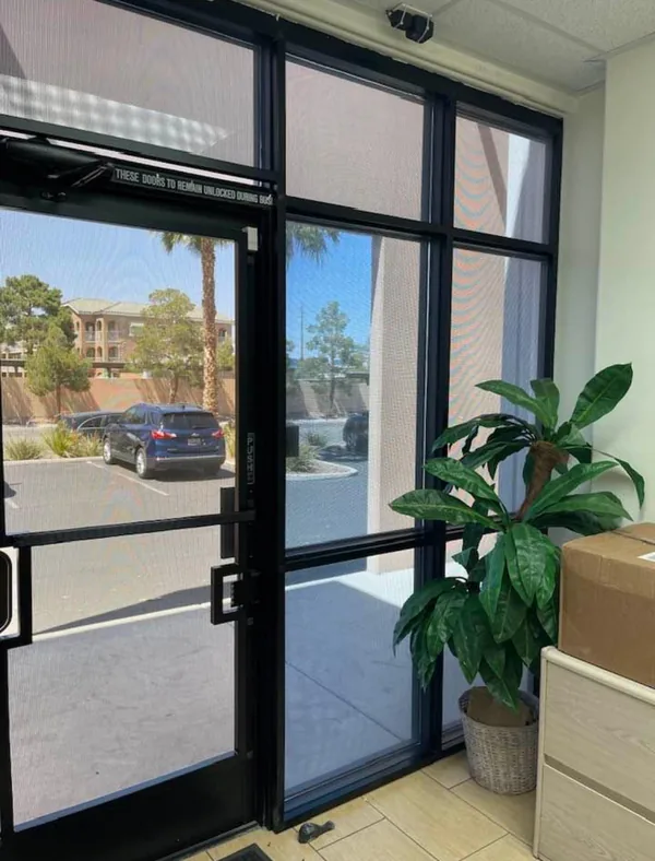 Commercial Storefront Security Screens for Doors and Windows — interior view of paired mesh doors with flanking mesh panels in a Las Vegas business lobby, by Olson Iron