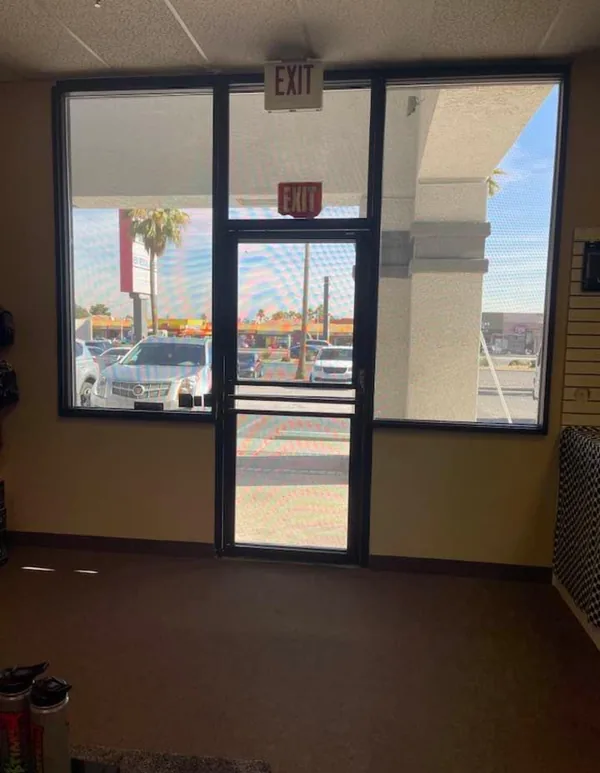 Commercial Storefront Security Screens for Doors and Windows — interior view of a Las Vegas retail showroom protected by a full mesh storefront, by Olson Iron