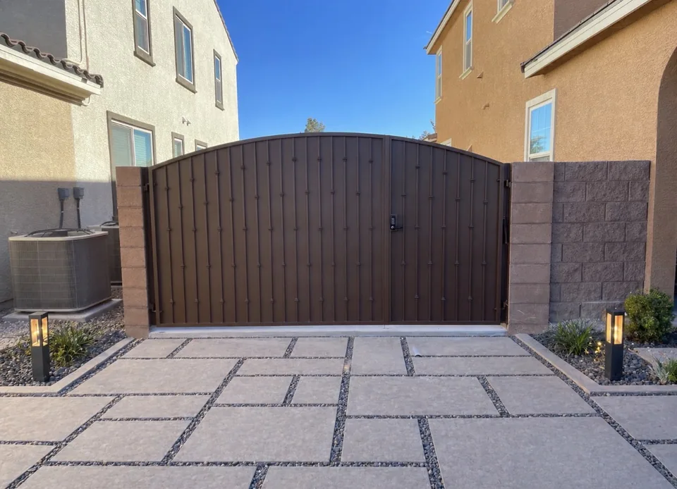 Olson Iron custom RV / driveway gate in Las Vegas — bronze flat-panel double rv gate with decorative rivets and arched top in Las Vegas (713G)