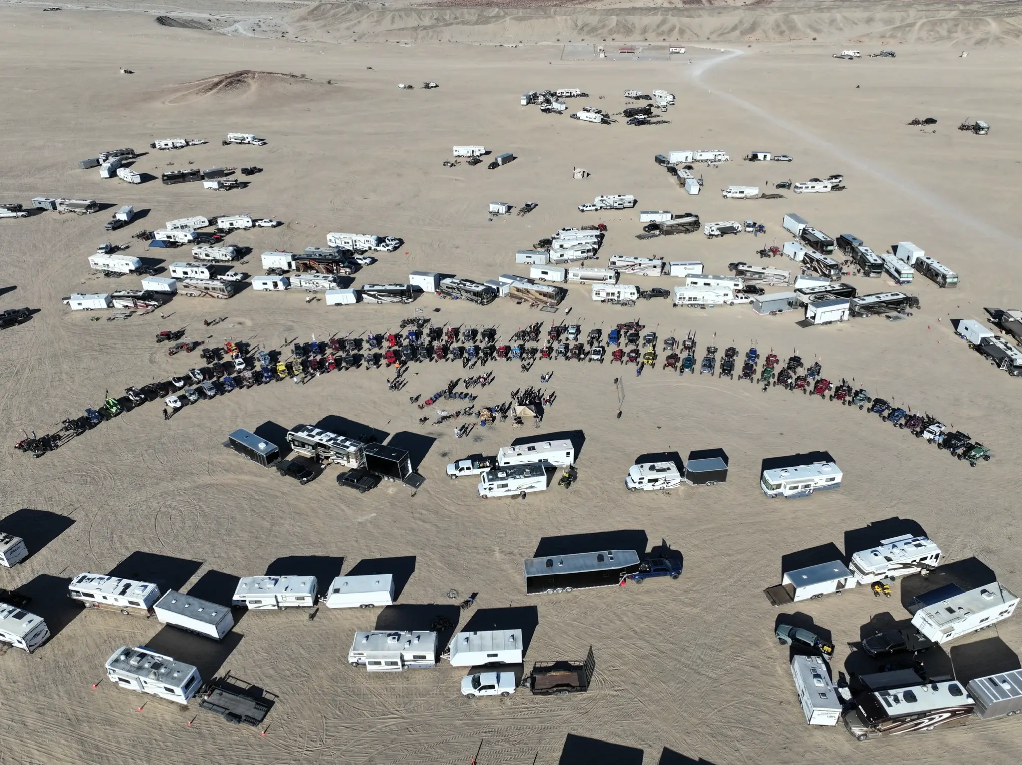 Aerial view of the full dunes camp with RVs and off-road vehicles