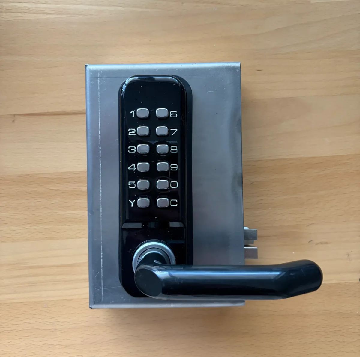 Olson Mechanical Code Lock installed in welded steel gate box, face view showing 12-button keypad and lever handle