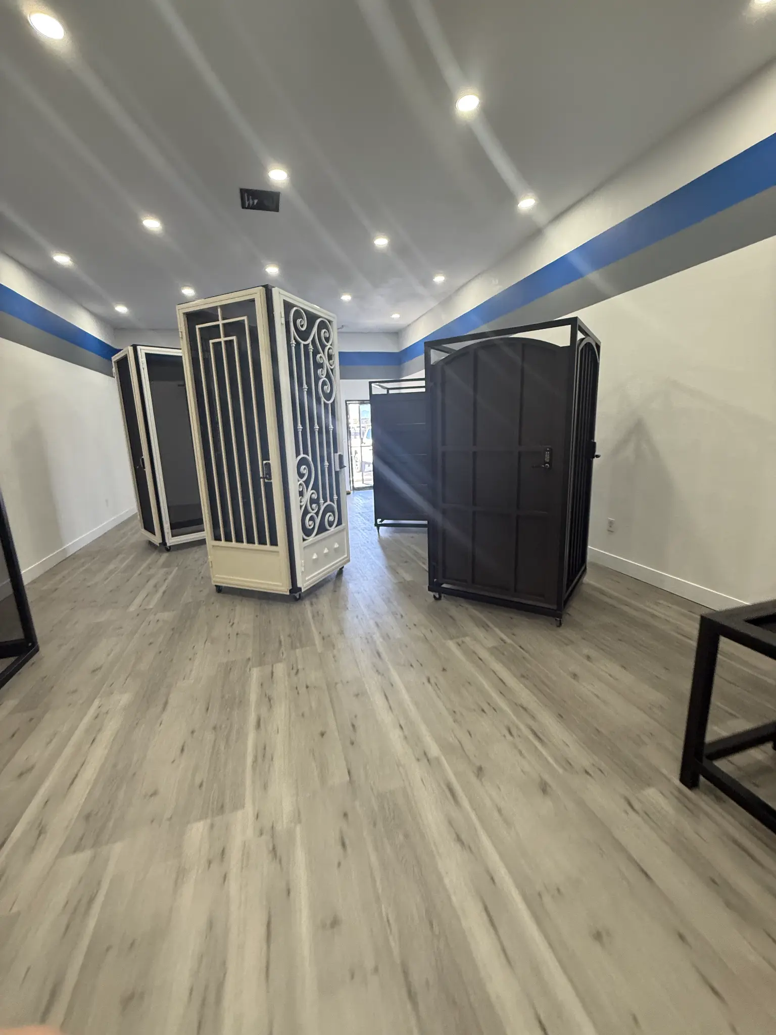 Decorative metal security doors and gates on display in the Olson Iron showroom