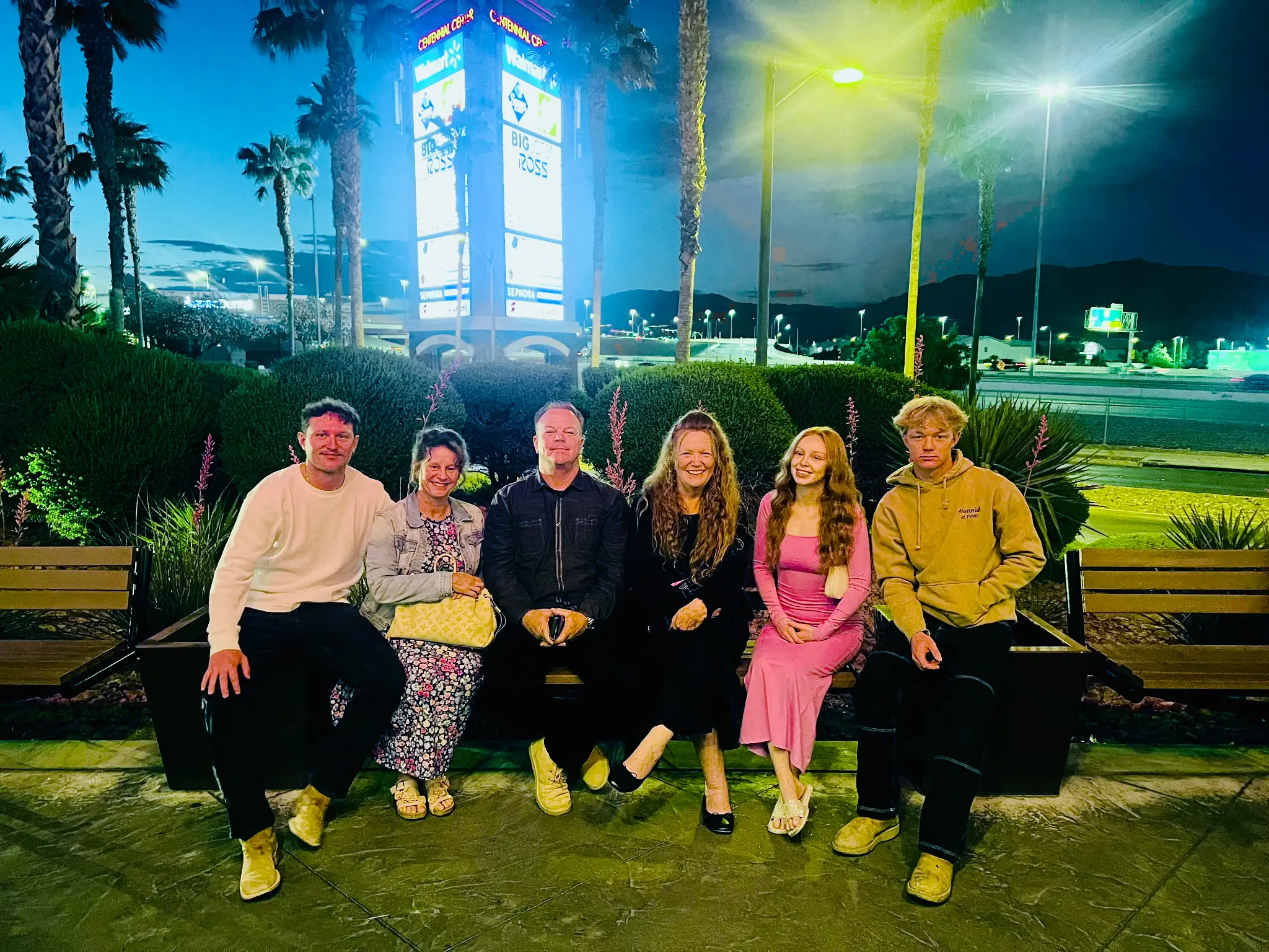Olson family group on a bench at night