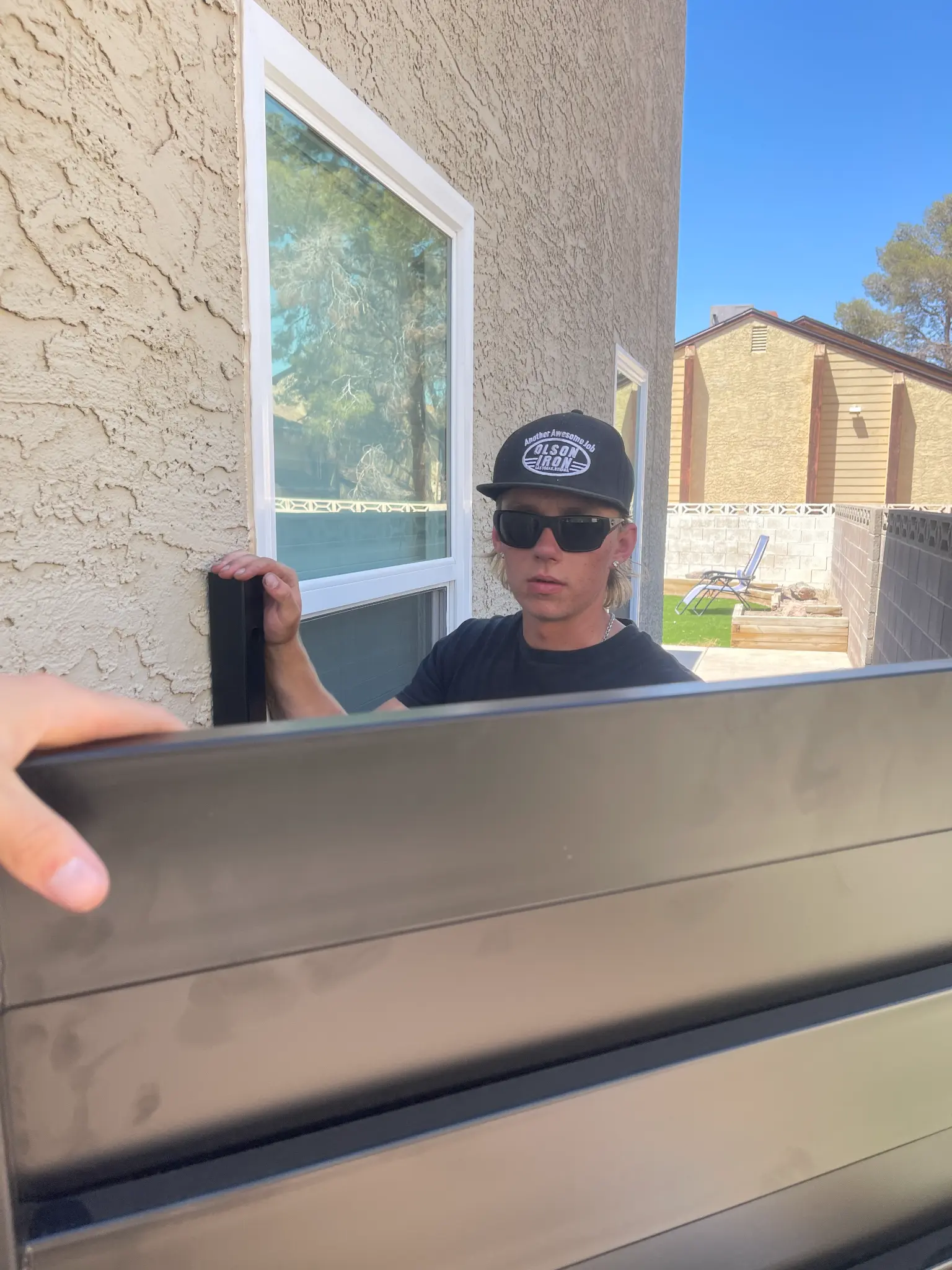 Olson Iron team member installing a security screen door in Las Vegas