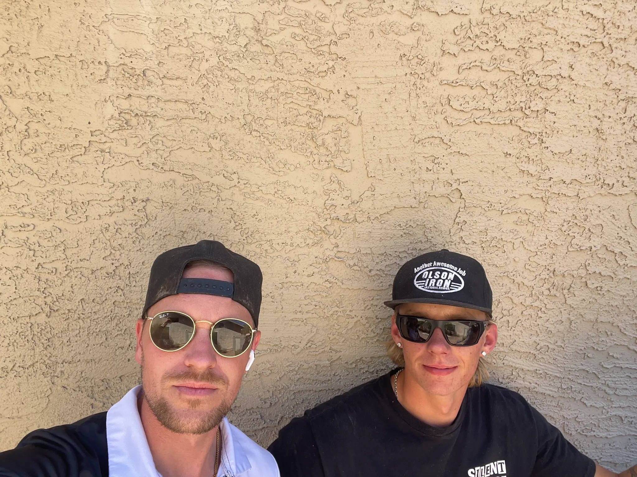 Jay and Landon posing against a wall on a Las Vegas job site