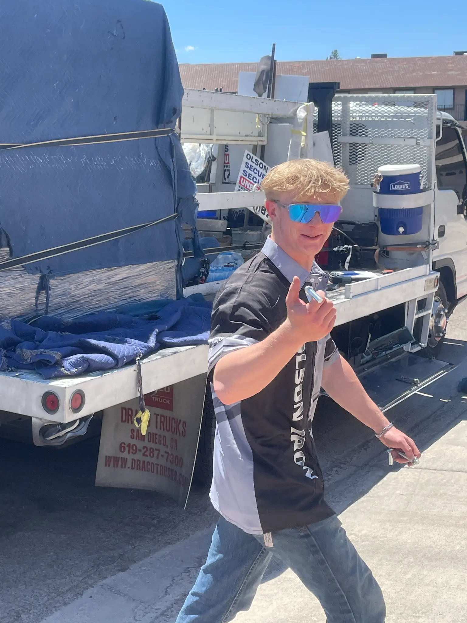 Olson Iron team member giving a thumbs up at the work truck