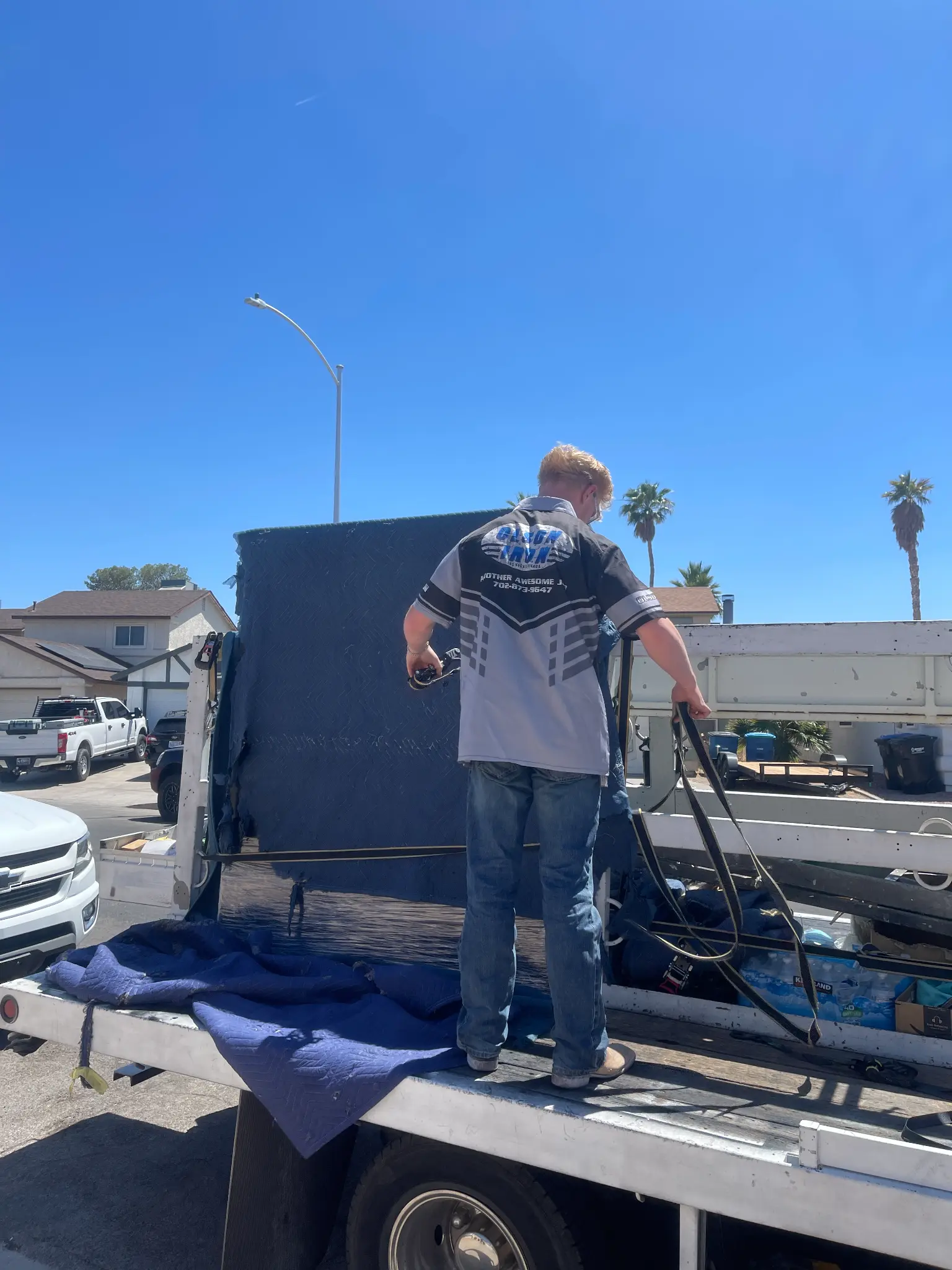 Landon unloading the Olson Iron truck at a job site